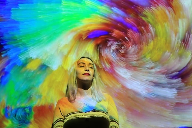 unsplash image by Natalie Sierra of woman with swirling chakra colors
